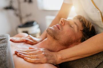 Man relaxing during a chest massage at a spa with a serene expression. Wellness Hotel Concept image : Stock Photo or Stock Video Download rcfotostock photos, images and assets rcfotostock | RC Photo Stock.: