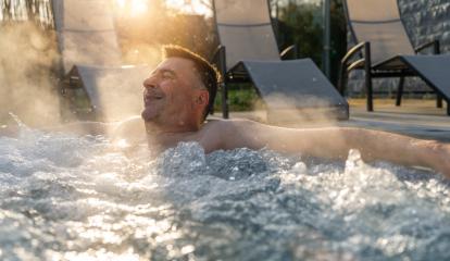 Man relaxing in a hot tub with sun rays and steam around him. Spa wellness hotel concept image. : Stock Photo or Stock Video Download rcfotostock photos, images and assets rcfotostock | RC Photo Stock.: