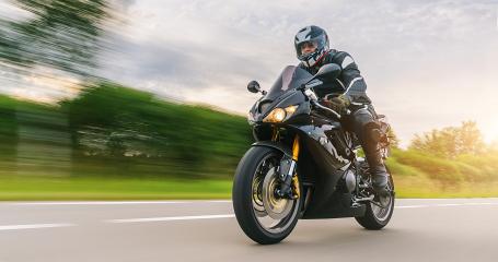 Man Riding Motorcycle On Road Against Cloudy Sky- Stock Photo or Stock Video of rcfotostock | RC Photo Stock