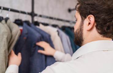 Man selecting a jacket from a clothing rack in a store : Stock Photo or Stock Video Download rcfotostock photos, images and assets rcfotostock | RC Photo Stock.: