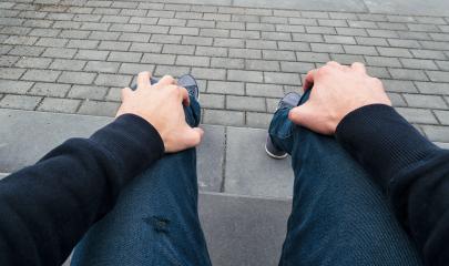 man sits on a curbstone and waits nervous for somebody, Point of view shot- Stock Photo or Stock Video of rcfotostock | RC-Photo-Stock