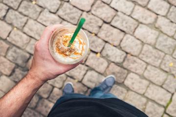 Man standing on brick ground and drinks caramel coffee in a plastic cup. lifestyle person pov Point of view shot- Stock Photo or Stock Video of rcfotostock | RC-Photo-Stock