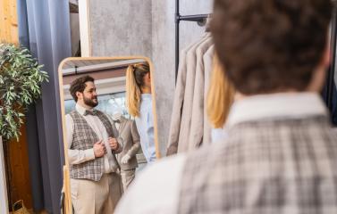 Man trying on a vest in front of a mirror in a clothing store with a tailor assisting : Stock Photo or Stock Video Download rcfotostock photos, images and assets rcfotostock | RC Photo Stock.: