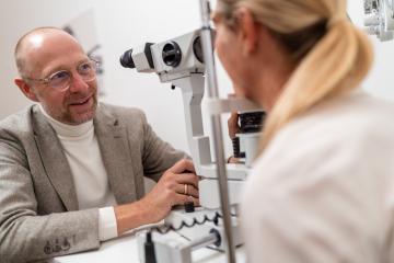 Man undergoing an eye examination using a slit lamp at the clinic. Close-up photo. Healthcare and medicine concept- Stock Photo or Stock Video of rcfotostock | RC Photo Stock