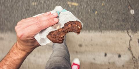 Man walking on sidewalk in the city street with bitten Chocolate Chip Cookie in his hand, point of view perspective.- Stock Photo or Stock Video of rcfotostock | RC Photo Stock