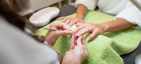 Manicurist performing a cuticle care procedure on a client in a salon in a beauty salon- Stock Photo or Stock Video of rcfotostock | RC Photo Stock