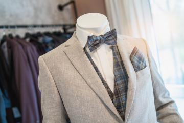 Mannequin dressed in a light gray suit with a plaid bow tie and matching pocket square at a wedding store : Stock Photo or Stock Video Download rcfotostock photos, images and assets rcfotostock | RC Photo Stock.: