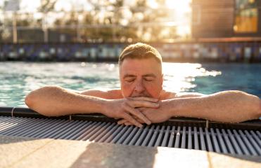 Mature man with closed eyes, resting arms on pool edge for relax- Stock Photo or Stock Video of rcfotostock | RC Photo Stock