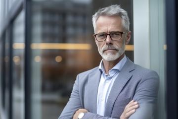 Mature man with glasses in a light grey suit by the window- Stock Photo or Stock Video of rcfotostock | RC Photo Stock
