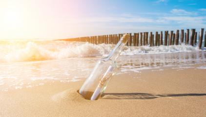 Message in a bottle on the beach with groynes- Stock Photo or Stock Video of rcfotostock | RC Photo Stock