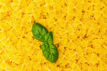 mini Farfalle noodles with basil leaf background- Stock Photo or Stock Video of rcfotostock | RC Photo Stock