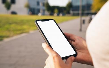 Mockup image of hands holding black mobile phone with blank desktop screen at summer in the city- Stock Photo or Stock Video of rcfotostock | RC Photo Stock