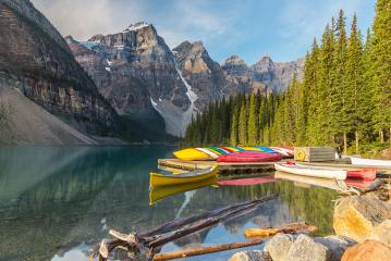 Moraine Lake and boat with snow capped mountain of Banff National Park in canada- Stock Photo or Stock Video of rcfotostock | RC Photo Stock