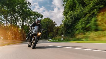 motorbike riding on the road at summer. driving on the empty road on a motorcycle tour journey. copyspace for your individual text.- Stock Photo or Stock Video of rcfotostock | RC Photo Stock