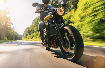 Motorcycle driver riding in Alpine highway at sunset- Stock Photo or Stock Video of rcfotostock | RC Photo Stock