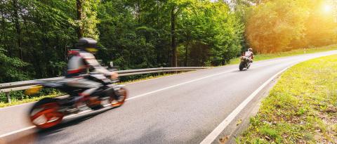 motorcycles on the forest road riding fast. having fun driving the empty road on a motorcycle tour journey. copyspace for your individual text.- Stock Photo or Stock Video of rcfotostock | RC Photo Stock