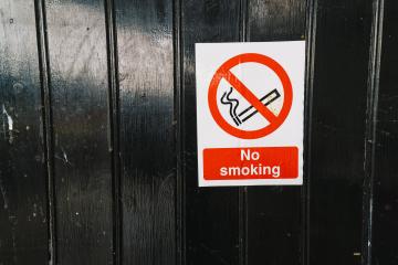 No smoking sign on a black wood en door, copy space for individual text- Stock Photo or Stock Video of rcfotostock | RC-Photo-Stock
