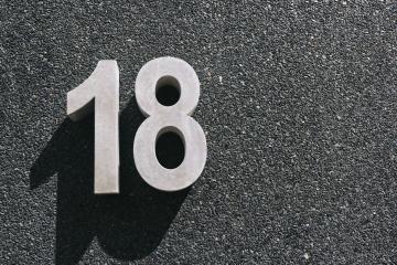 number 18 hanging of a black concrete wall- Stock Photo or Stock Video of rcfotostock | RC-Photo-Stock