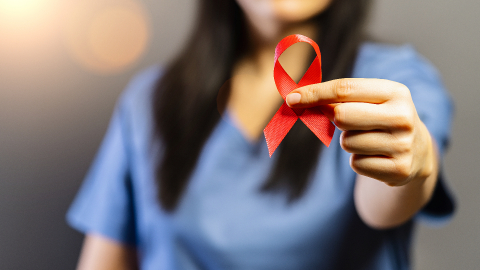 Nurse holds red badge ribbon in hands to support AIDS Day. Healthcare, medicine and AIDS awareness concept.- Stock Photo or Stock Video of rcfotostock | RC Photo Stock