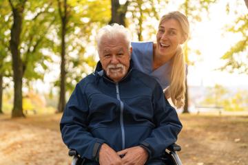 nurse visiting her elderly patient in nursing home having a walk in the park with him in a wheelchair, both smiling brightly : Stock Photo or Stock Video Download rcfotostock photos, images and assets rcfotostock | RC Photo Stock.: