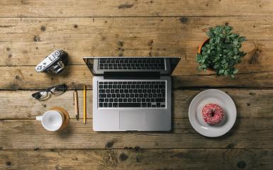 office stuff with photo camera, laptop and coffee cup, donut, plant top view shot, with copyspace for your individual text.- Stock Photo or Stock Video of rcfotostock | RC-Photo-Stock