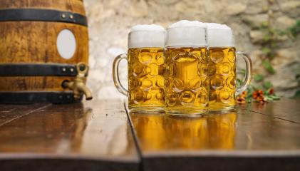 Oktoberfest beer glasses full of german beer with wooden barrel, Munich, Germany- Stock Photo or Stock Video of rcfotostock | RC Photo Stock