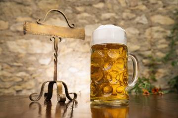 Oktoberfest beer on a wooden table with metal plate, Munich, Germany - Stock Photo or Stock Video of rcfotostock | RC Photo Stock