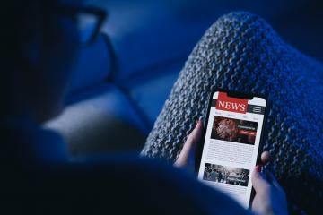 Online Corona news on a mobile phone. woman reading news or articles  about covid-19 in a smartphone screen application at the sofa. Hand holding smart device. Mockup website. COVID 19 nCov Outbreak.- Stock Photo or Stock Video of rcfotostock | RC-Photo-Stock