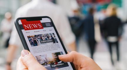 Online news on a mobile phone. Close up of businesswoman reading news or articles in a smartphone screen application. Hand holding smart device. Mockup website. Newspaper and portal on internet.- Stock Photo or Stock Video of rcfotostock | RC Photo Stock