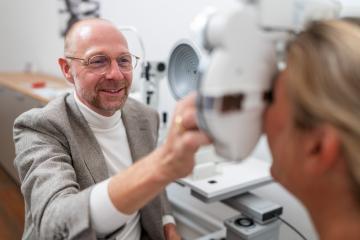 optician executes a refraction test with a phoropter on a female- Stock Photo or Stock Video of rcfotostock | RC Photo Stock