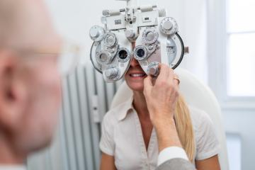 Optometrist adjusting a phoropter for a female patient during an : Stock Photo or Stock Video Download rcfotostock photos, images and assets rcfotostock | RC Photo Stock.: