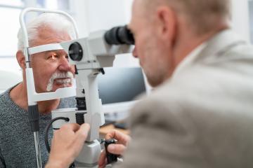 Optometrist using a slit lamp to examine a senior man's eye at t- Stock Photo or Stock Video of rcfotostock | RC Photo Stock