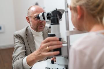 Optometrist using slit lamp machine to examine a child patient's eyes in eyes clinic- Stock Photo or Stock Video of rcfotostock | RC Photo Stock