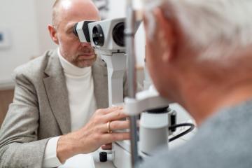 Optometrist using specialized equipment slit-lamp to examine an - Stock Photo or Stock Video of rcfotostock | RC Photo Stock