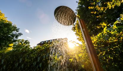 Outdoor shower head stick on the wooden pole design for showering body before jumping in the resort pool. Golden Hour Refreshment Spa wellness concept image- Stock Photo or Stock Video of rcfotostock | RC Photo Stock