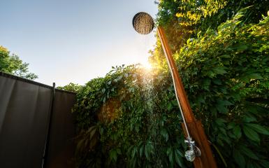 Outdoor shower sprinkler in the garden for swimming in the resort pool at sunset. Golden Hour Refreshment Spa wellness concept image- Stock Photo or Stock Video of rcfotostock | RC Photo Stock