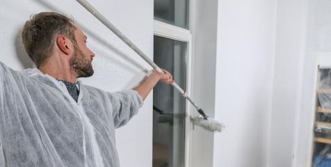 painter working with paint roller to paint the corner of a room window with white color. do it yourself concept image- Stock Photo or Stock Video of rcfotostock | RC Photo Stock