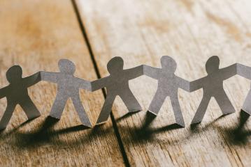 Paper People Holding Hands on a wooden table : Stock Photo or Stock Video Download rcfotostock photos, images and assets rcfotostock | RC Photo Stock.: