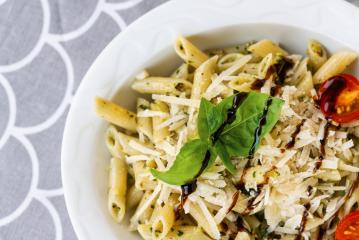 Pasta with vegetables, Parmesan, basil and creamy sauce in a bowl on table background. Top view- Stock Photo or Stock Video of rcfotostock | RC-Photo-Stock