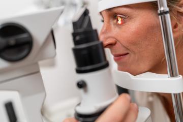 Patient undergoing an eye examination with a focus on her illuminated eye using a slit lamp at the clinic. Close-up photo. Healthcare and medicine concept- Stock Photo or Stock Video of rcfotostock | RC Photo Stock