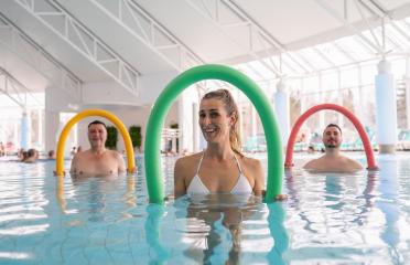 Patients during remobilization in a health center doing aquarobics with pool noodle in the water of a pool : Stock Photo or Stock Video Download rcfotostock photos, images and assets rcfotostock | RC Photo Stock.: