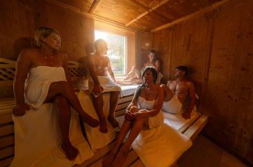 People sitting in a sauna, some talking and relaxing together in hot finnish sauna. dramtic light with Steam, spa and wellness concept.- Stock Photo or Stock Video of rcfotostock | RC Photo Stock