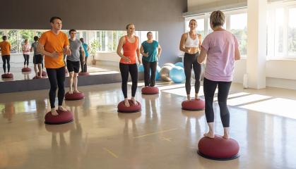 People training balance on Bosu Balls during a group fitness session in a gym : Stock Photo or Stock Video Download rcfotostock photos, images and assets rcfotostock | RC Photo Stock.: