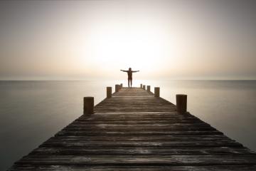 Person stands with open arms on the pier at sunrise. Powerful mediations, relaxation, recharge your batteries and enjoy life. : Stock Photo or Stock Video Download rcfotostock photos, images and assets rcfotostock | RC-Photo-Stock.: