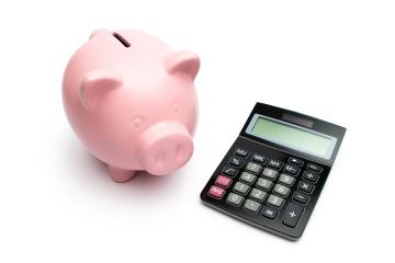 Piggybank with a black calculator on white background- Stock Photo or Stock Video of rcfotostock | RC-Photo-Stock