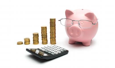 Pink Piggy Bank with Calculator and stacked coins- Stock Photo or Stock Video of rcfotostock | RC Photo Stock