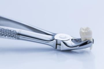 Pliers for wisdom tooth removal by a dentist- Stock Photo or Stock Video of rcfotostock | RC-Photo-Stock