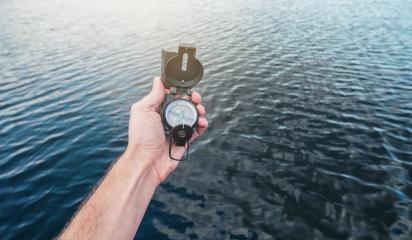 Point of view shot. Traveler man searching direction with a compass at the sea. - Stock Photo or Stock Video of rcfotostock | RC-Photo-Stock