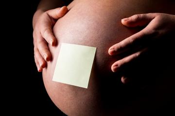 Pregnant woman caressing her belly with Sticky Note : Stock Photo or Stock Video Download rcfotostock photos, images and assets rcfotostock | RC-Photo-Stock.: