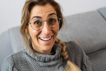 Pretty girl with pigtail, wearing glasses and gray sweatshirt, laughing. Close-up front portrait indoors with copy space : Stock Photo or Stock Video Download rcfotostock photos, images and assets rcfotostock | RC Photo Stock.: